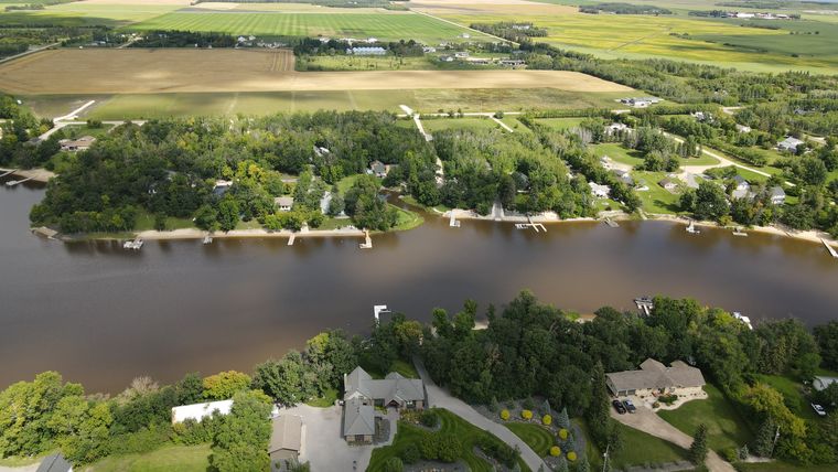 Lake Winnipeg opening out beyond the treeline north of the development