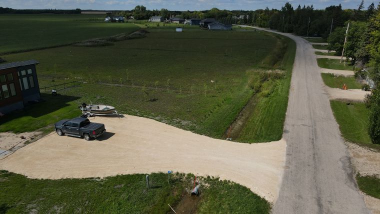 The gravel approach at road level, looking along Palmer Road